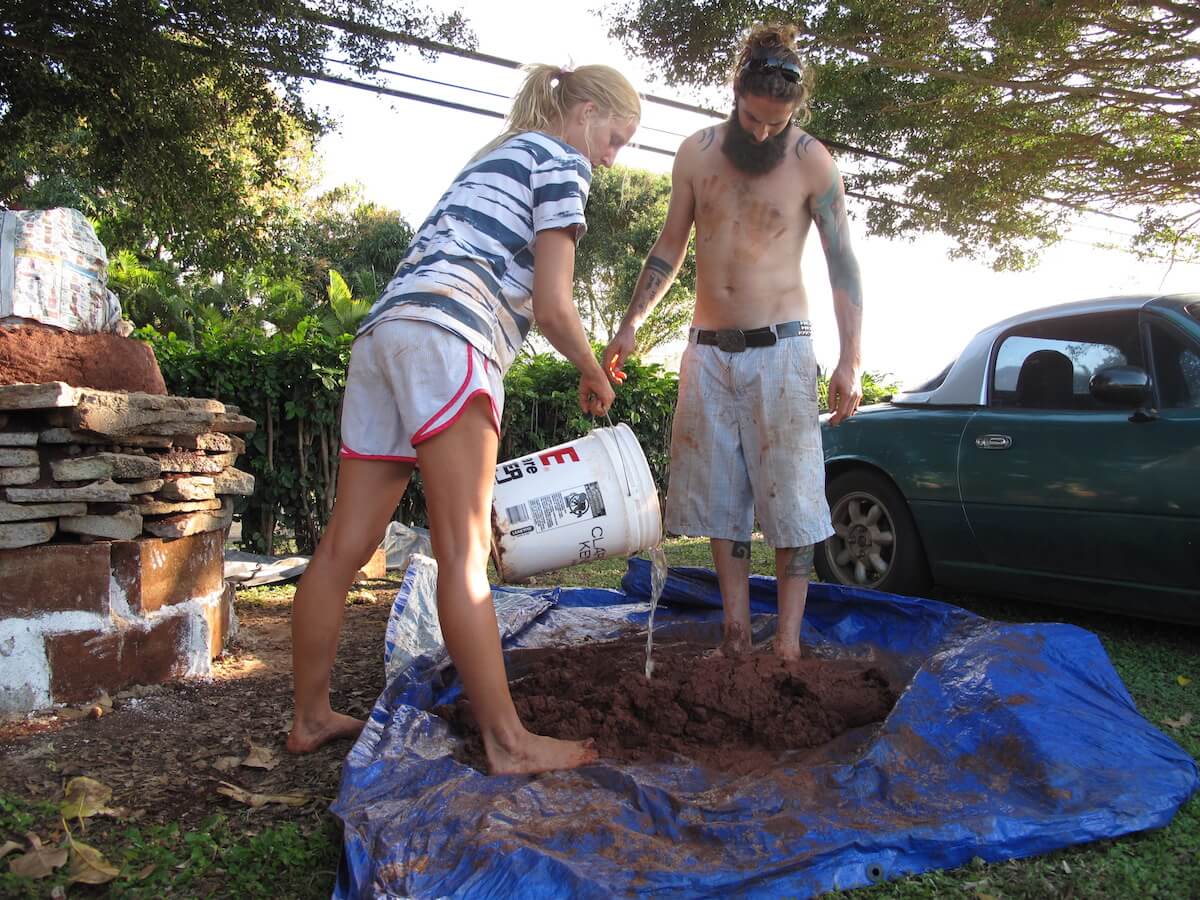 mixing a batch of cob for an earthbag dome