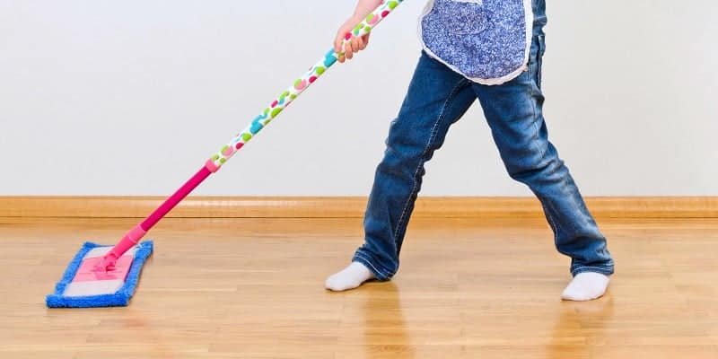 kid cleaning the floor