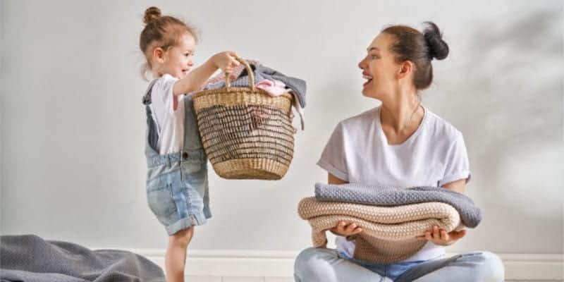 mom and daughter folding laundry 